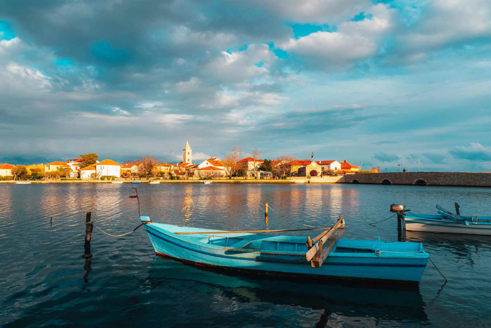 Scenic,Coastal,View,With,A,Blue,Wooden,Fishing,Boat,On